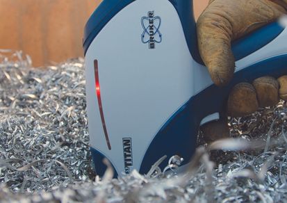 hand with Bruker S1 Sorter does PMI testing