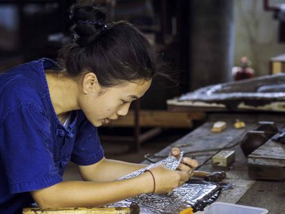 young woman tests the purity of silver