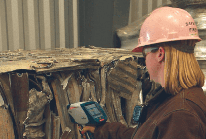 woman analyzes aluminium scrap for recycling with Bruker S1 Titan
